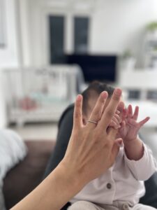 baby hand holding mums finger